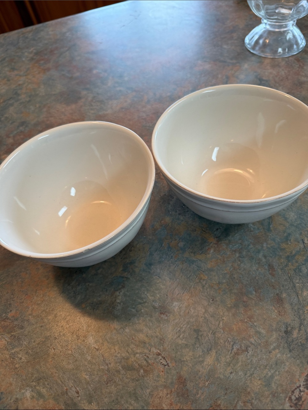 Pottery Barn cream color cereal/soup bowls handcrafted in Portugal. Chip on one.